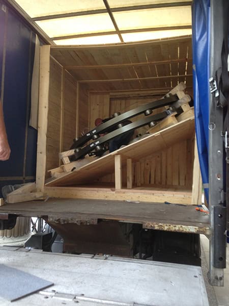 Electrical tools stored securely in a wooden crate inside a moving truck.