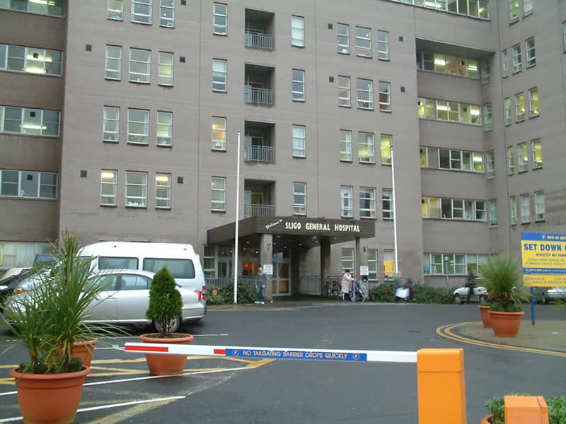 Sligo General Hospital building in Ireland with parking area.