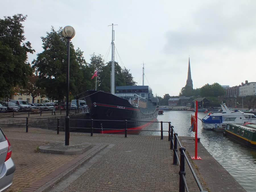 Boat docked at the harbor with electrical infrastructure in the background.