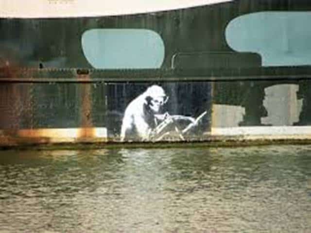 Graffiti of a grim reaper on a bridge wall, inspired by Banksy, with electrical work theme.